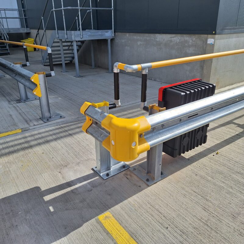 Armco 760HR Safety Barrier installed around a warehouse corner with a fire extinguisher box attached