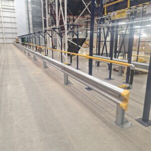 Armco 760HR Safety Barrier protecting a warehouse walkway, mezzanine structure, and overhead machinery inside a distribution centre