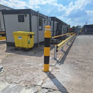 Yellow powder coated Armco 760HR Safety Barrier with Brandsafe ImpactSAFE bollard outside a site office