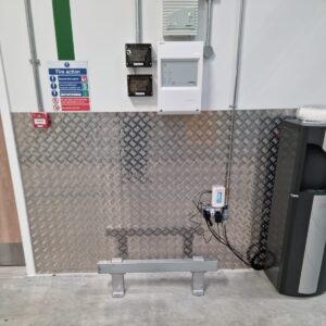 Low level steel impact barrier and checker plate wall protection shielding electrical switches from trolley damage